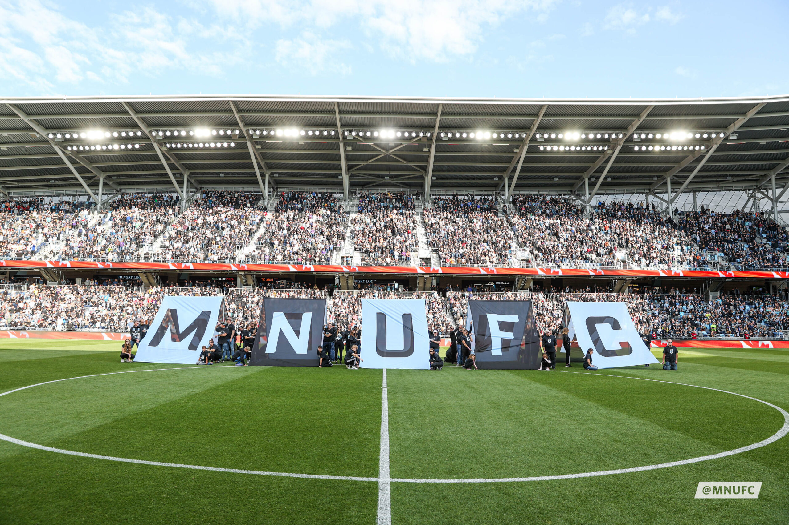 Minnesota United FC players in action at Allianz Field, celebrating partnership with TCEC.